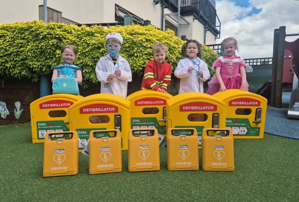 Defibrillator cabinets in front of mulbery nursery children